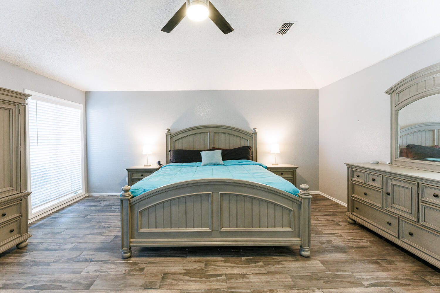 3713 95th Street Lubbock, TX 79423 - Photo 36 of 70 a bedroom with a bed and a dresser
