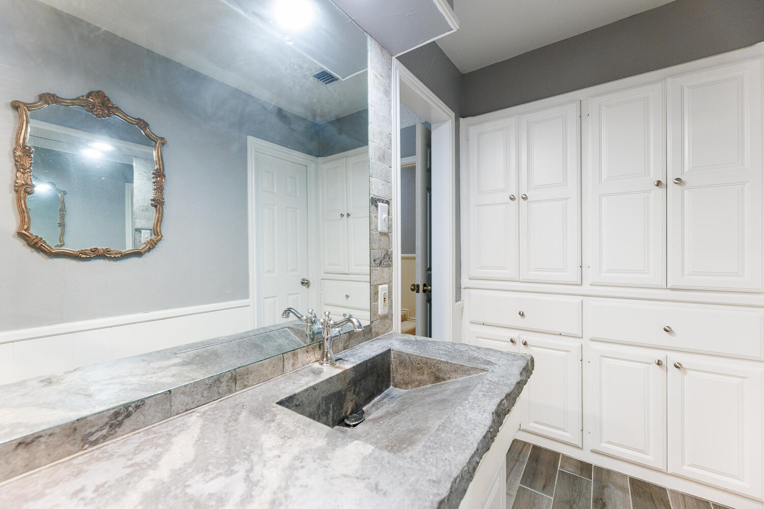 3713 95th Street Lubbock, TX 79423 - Photo 40 of 70 a bathroom with a granite countertop sink and a mirror