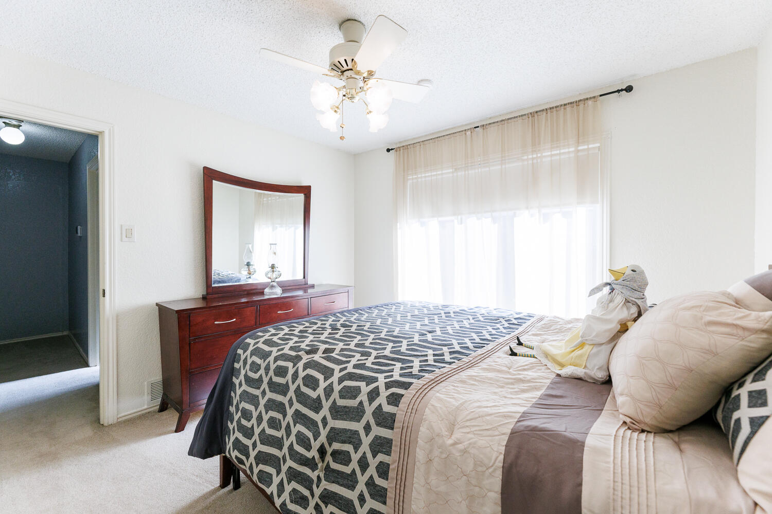 3713 95th Street Lubbock, TX 79423 - Photo 53 of 70 a bedroom with a bed and a chandelier