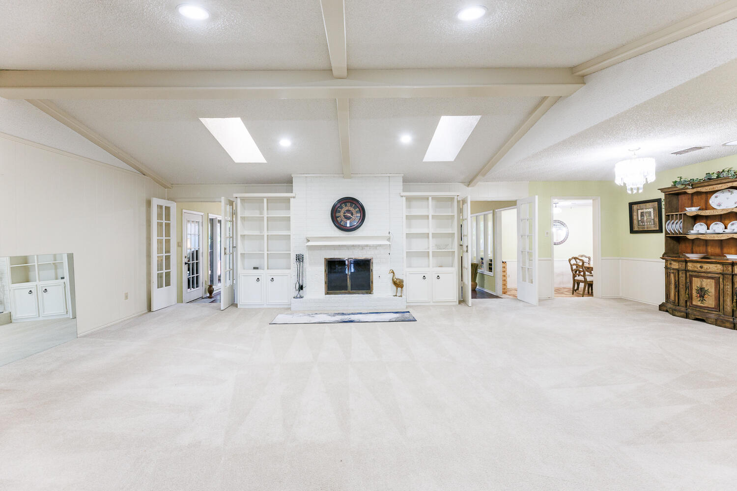 3713 95th Street Lubbock, TX 79423 - Photo 7 of 70 a view of an empty room with a fireplace and a window