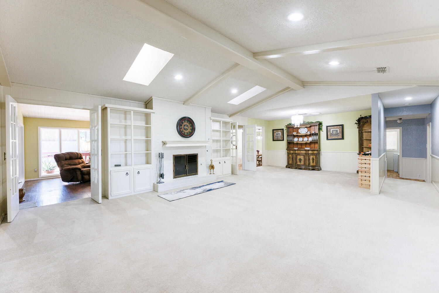 3713 95th Street Lubbock, TX 79423 - Photo 9 of 70 a view of a livingroom with a fireplace a ceiling fan and window