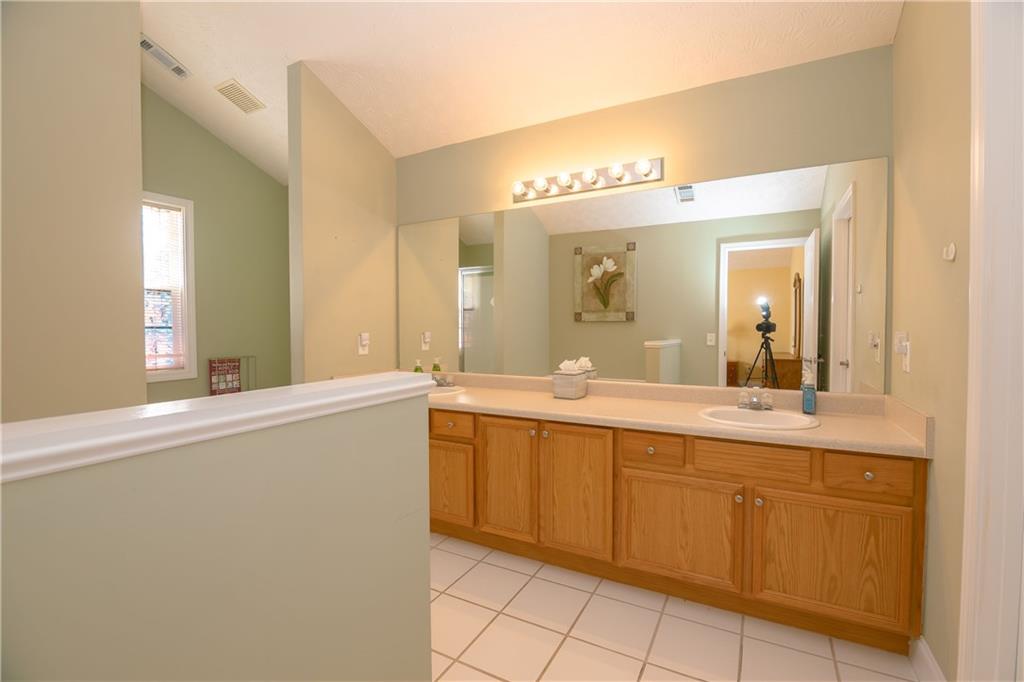 1200 Breckinridge Trail Winder, GA 30680 - Photo 16 of 37 a spacious bathroom with a granite countertop sink and a mirror
