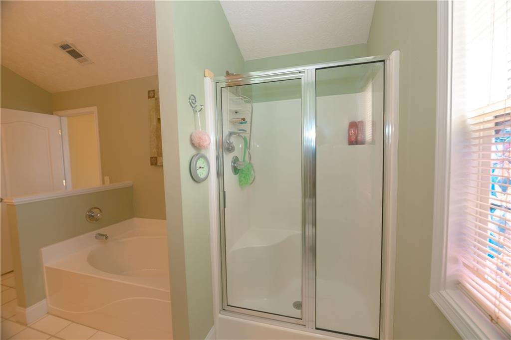 1200 Breckinridge Trail Winder, GA 30680 - Photo 19 of 37 a bathroom with a shower and a bathtub