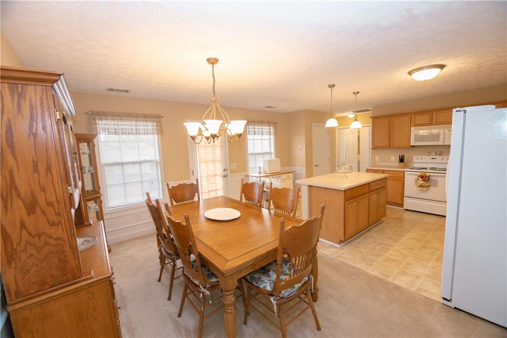 1200 Breckinridge Trail Winder, GA 30680 - Photo 7 of 37 a view of a dining room with furniture and a chandelier