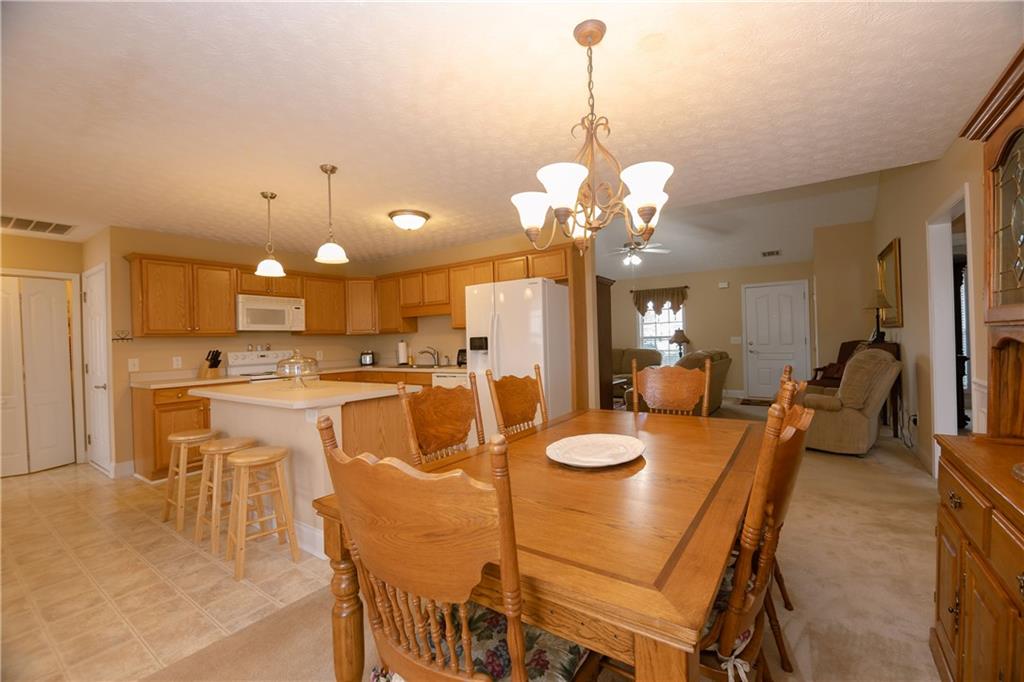 1200 Breckinridge Trail Winder, GA 30680 - Photo 9 of 37 a dining room filled chandelier and kitchen view