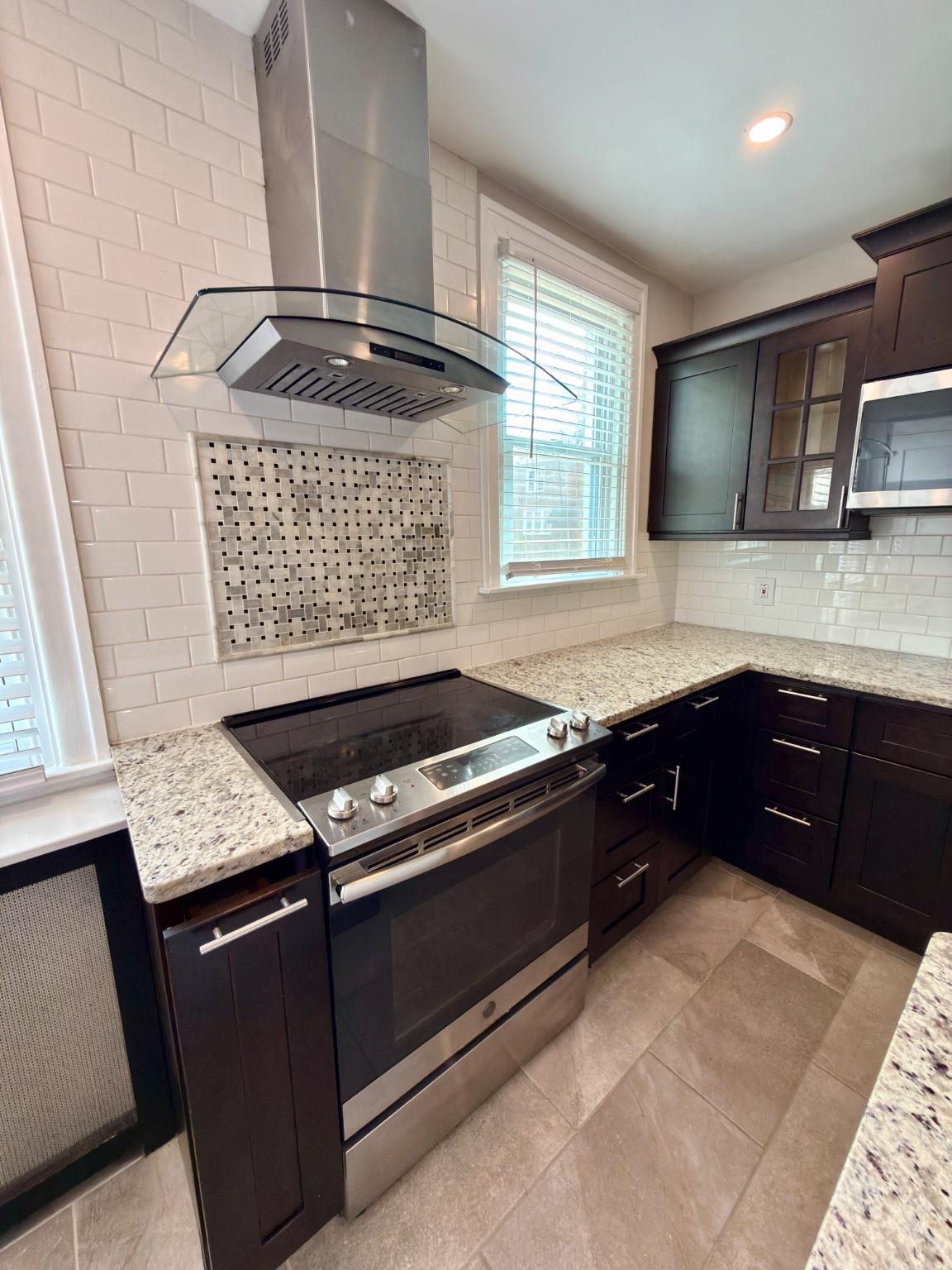 1723 Chelsea Road Elkins Park, PA 19027 - Photo 14 of 38 a kitchen with granite countertop a stove sink and cabinets