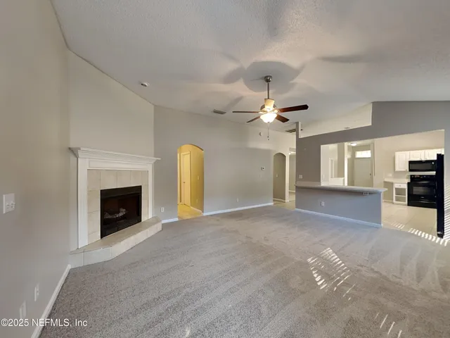 a view of a livingroom with a fireplace and window
