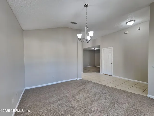 a view of a chandelier in big room and chandelier