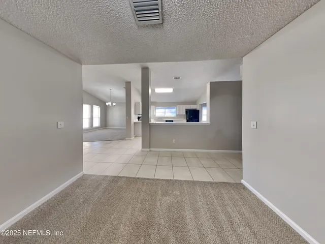 a view of a kitchen with a sink and a living room area