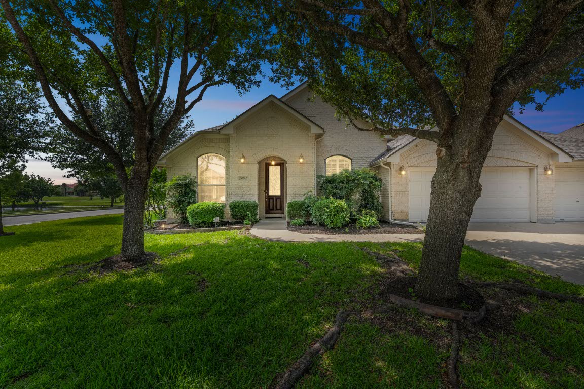 20700 Windmill Ridge Street Pflugerville, TX 78660 - Photo 1 of 1 a front view of a house with garden