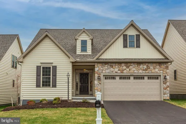 a view of a house with a yard and sitting space