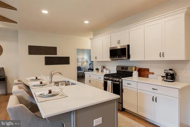 a kitchen that has a sink and a stove top oven