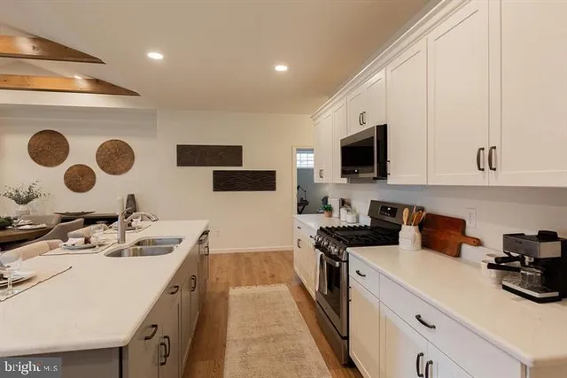 a kitchen with a sink a stove and cabinets