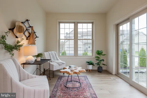 a view of a a dining room with furniture window and wooden floor