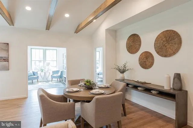 a dining room with furniture and a window