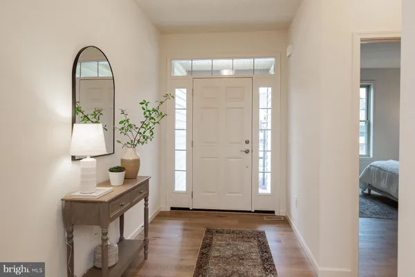 a view of an entryway with wooden floor