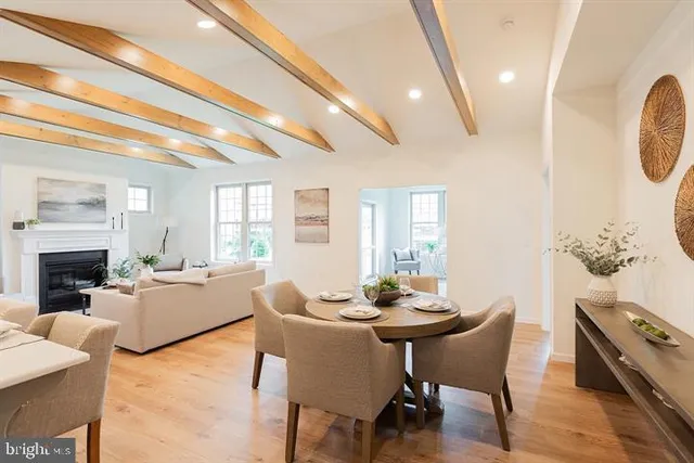 a living room with fireplace furniture and a potted plant
