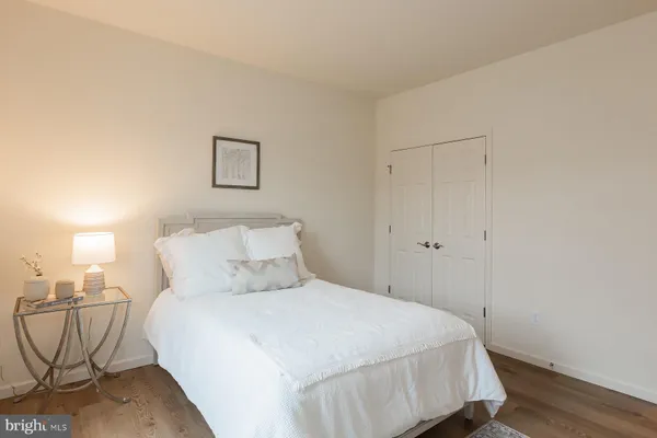 a bedroom with a bed and a potted plant