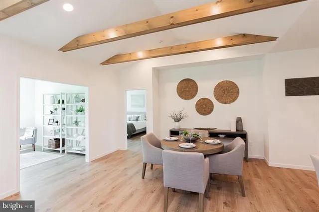 a dining room with furniture and wooden floor