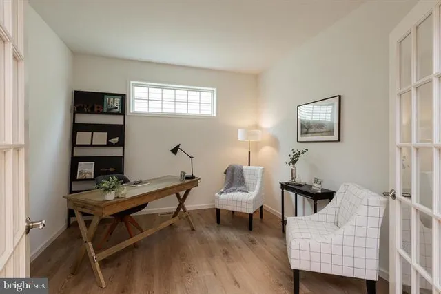 a living room with furniture a rug and a window