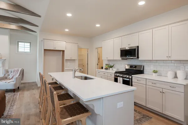 a large kitchen with a table and chairs