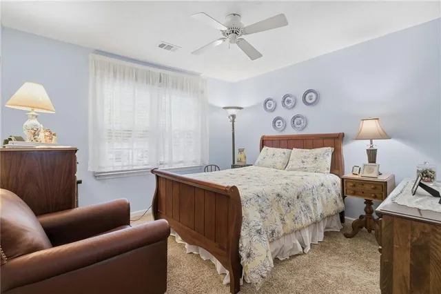 a bedroom with a bed couch and window