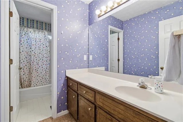 a bathroom with a sink a vanity and a mirror