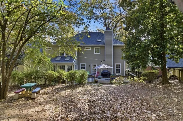 a view of a house with a yard and sitting area