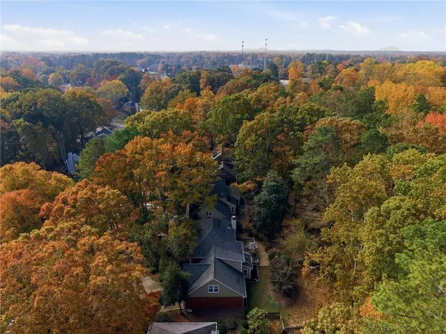an aerial view of house with yard and mountain view in back
