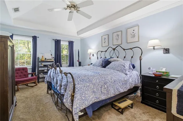 a bedroom with a bed and a chandelier