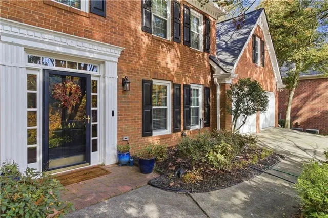 front view of a brick house with a large windows