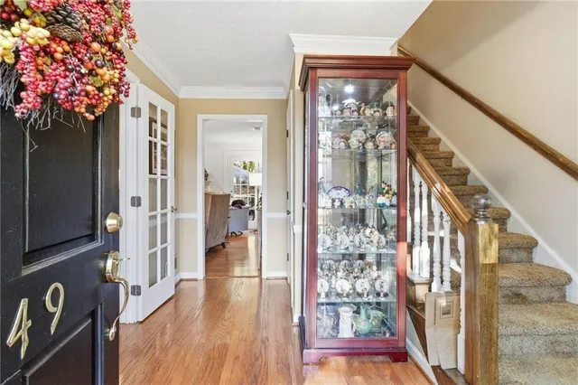 a view of a hallway with wooden floor and entryway