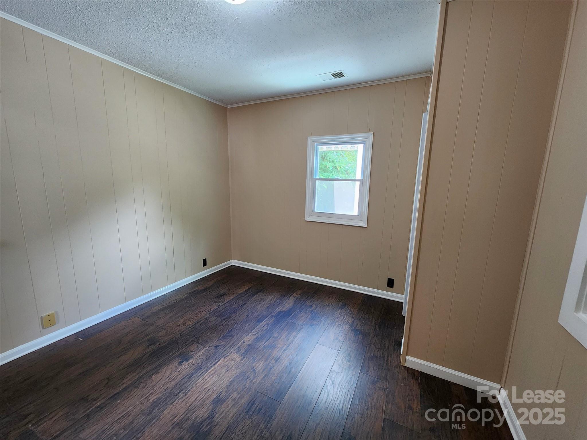 420 A Jackson Park Road Kannapolis, NC 28083 - Photo 14 of 20 an empty room with wooden floor and windows