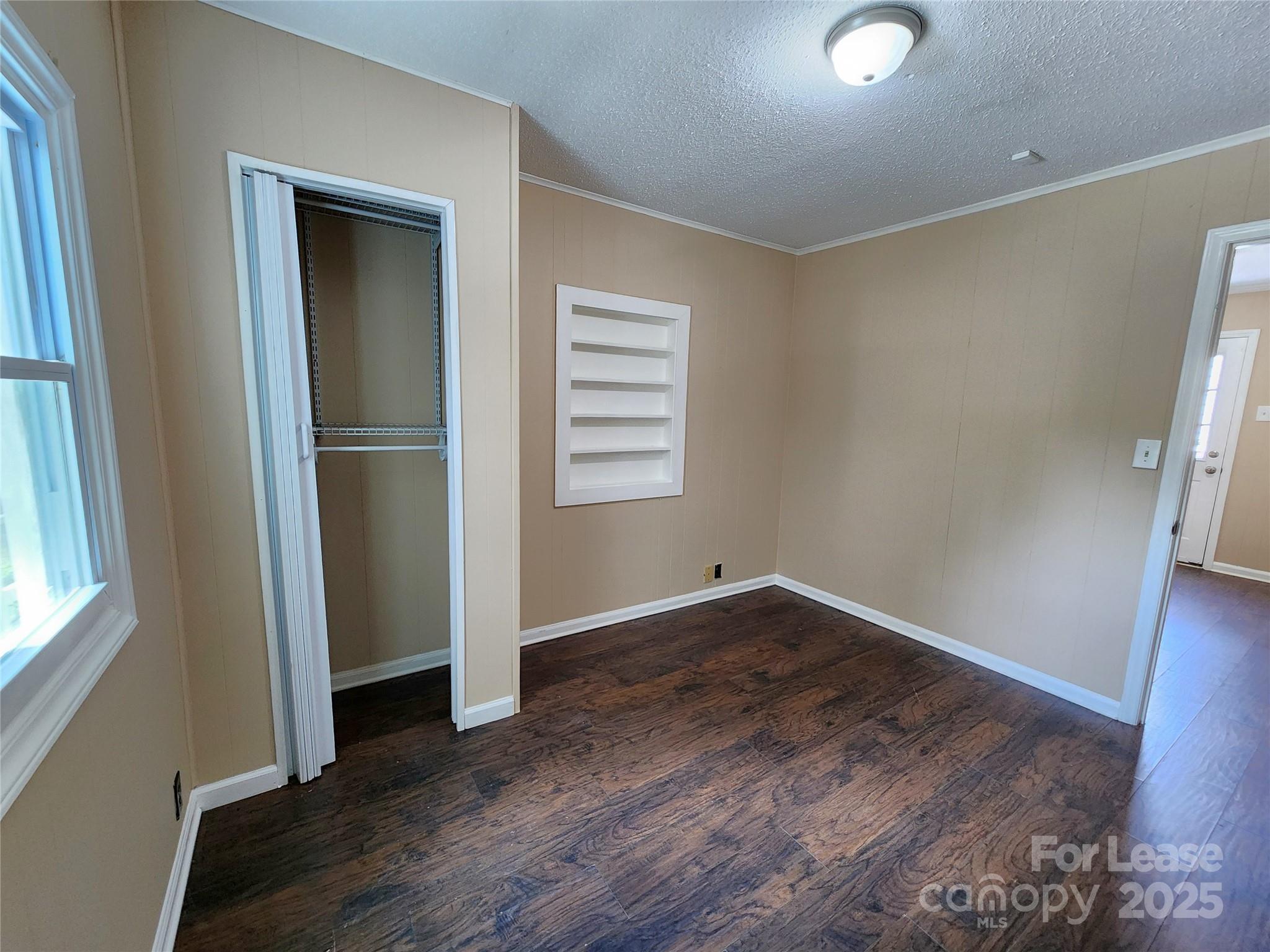 420 A Jackson Park Road Kannapolis, NC 28083 - Photo 15 of 20 an empty room with wooden floor closet and windows