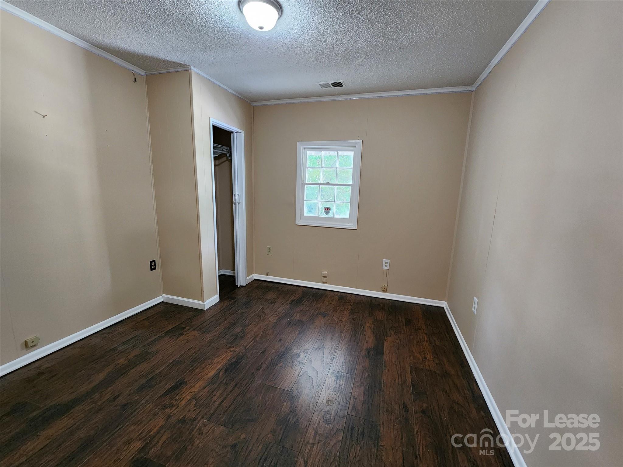 420 A Jackson Park Road Kannapolis, NC 28083 - Photo 16 of 20 an empty room with wooden floor and windows