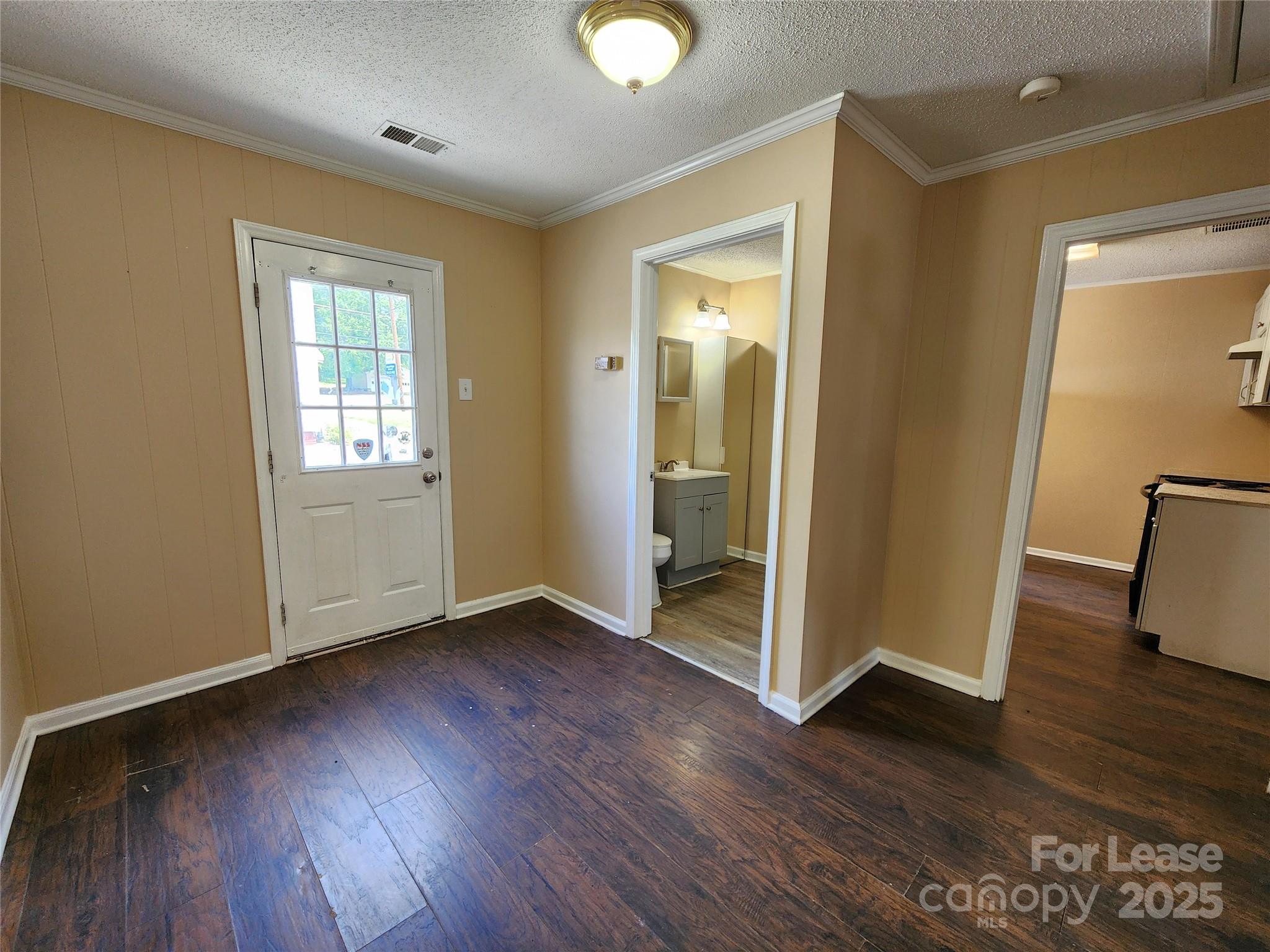 420 A Jackson Park Road Kannapolis, NC 28083 - Photo 3 of 20 a view of an empty room with wooden floor and a window