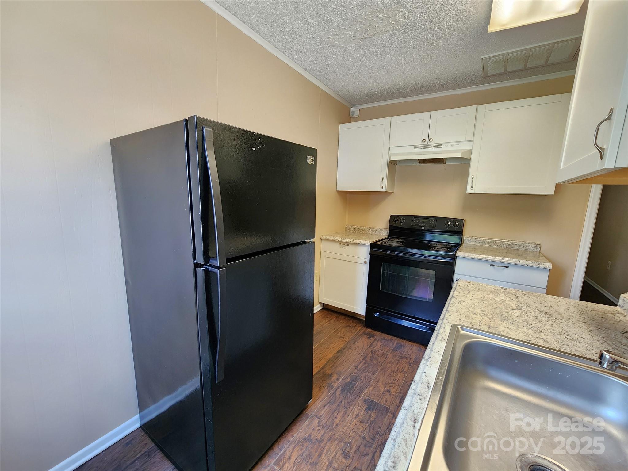 420 A Jackson Park Road Kannapolis, NC 28083 - Photo 5 of 20 a kitchen with a refrigerator and a sink