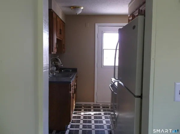 a kitchen with a refrigerator and a stove
