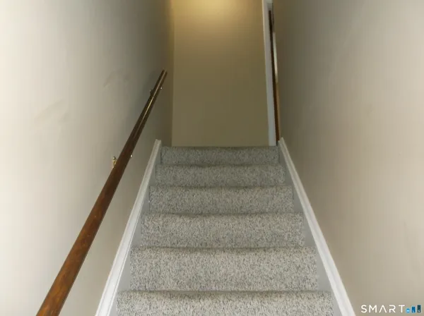 a view of staircase with white walls