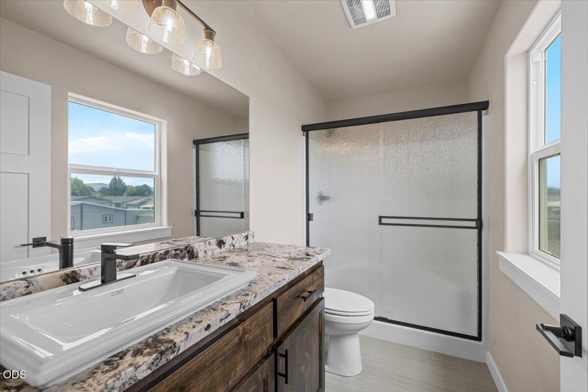 7869 Houston Loop White City, OR 97503 - Photo 12 of 15 a bathroom with a granite countertop sink toilet and shower