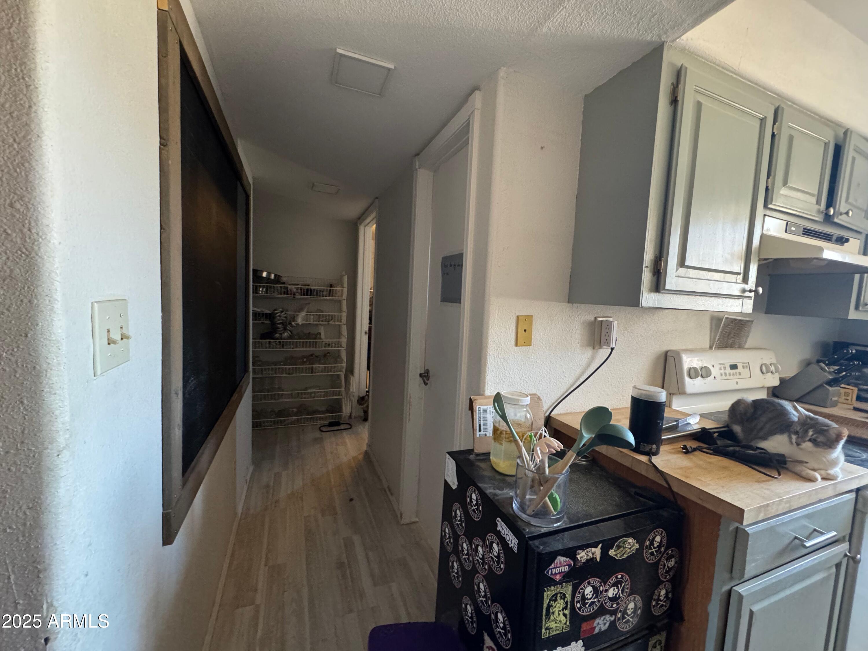56163 West Papago Road Maricopa, AZ 85139 - Photo 19 of 44 a kitchen with a stove and a refrigerator