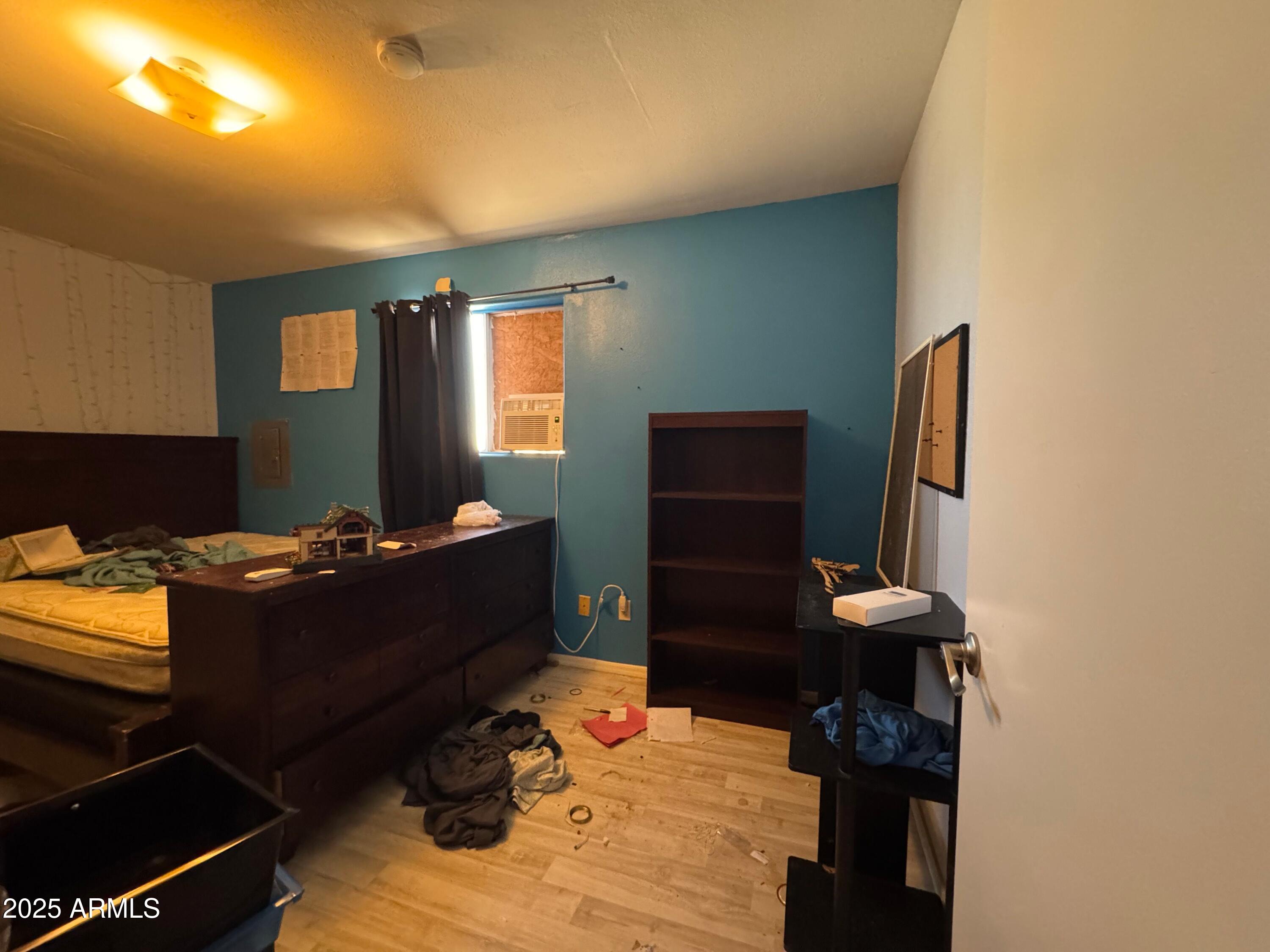 56163 West Papago Road Maricopa, AZ 85139 - Photo 21 of 44 a room with furniture and wooden floor
