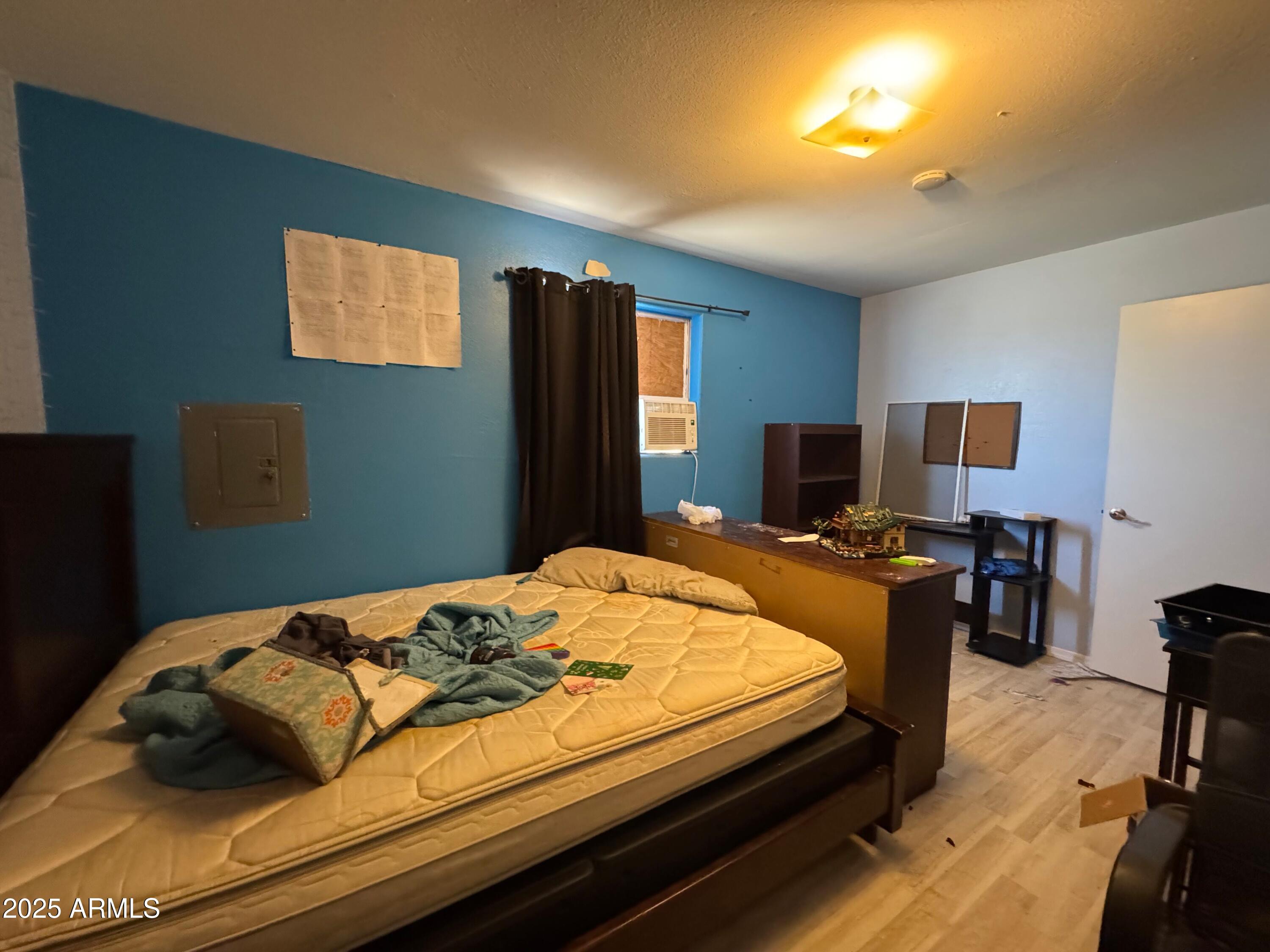 56163 West Papago Road Maricopa, AZ 85139 - Photo 23 of 44 a bedroom with a bed and furniture