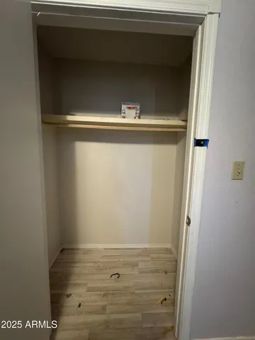 a view of hallway with wooden floor