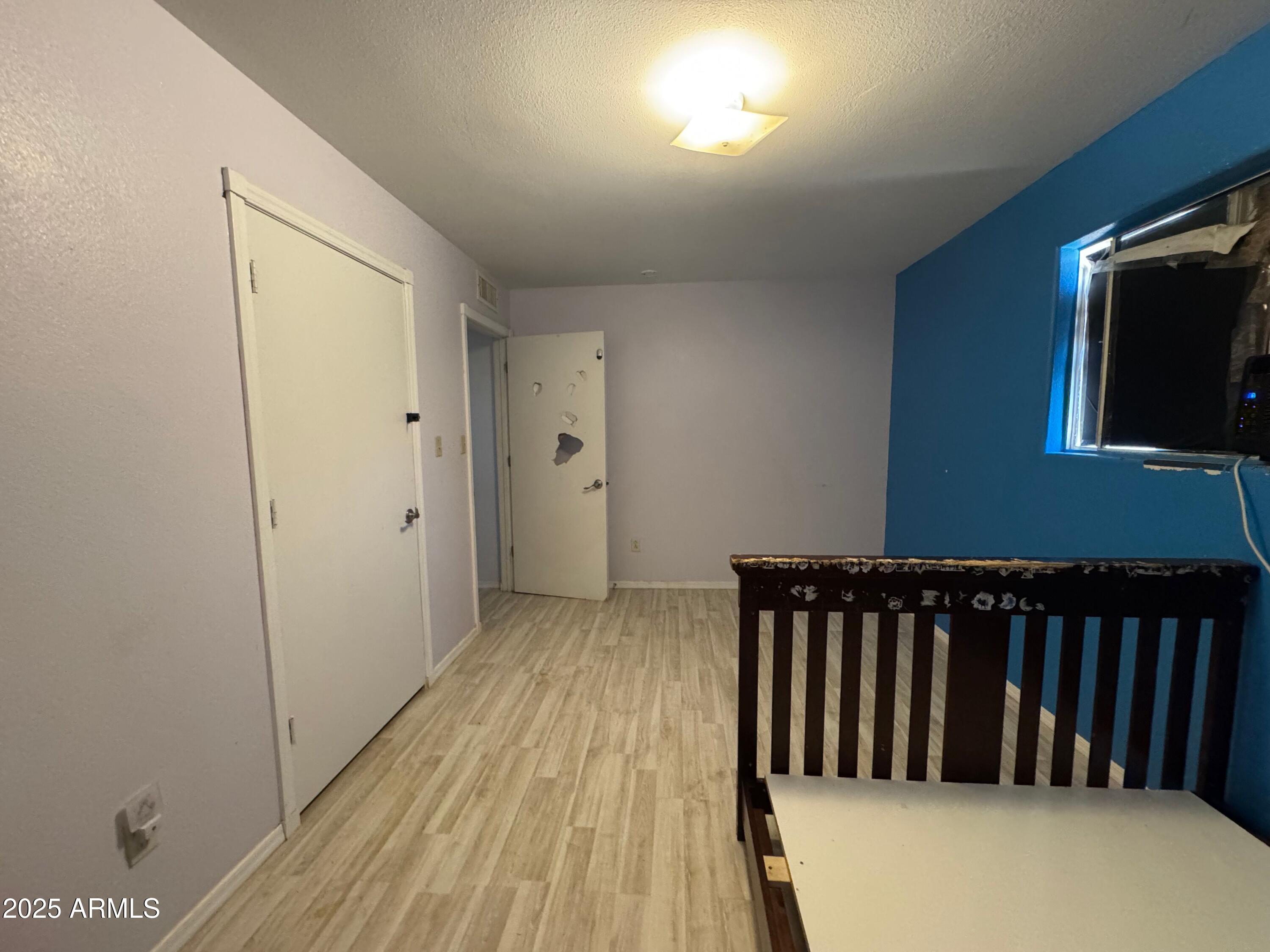 56163 West Papago Road Maricopa, AZ 85139 - Photo 27 of 44 a view of hallway with wooden floor