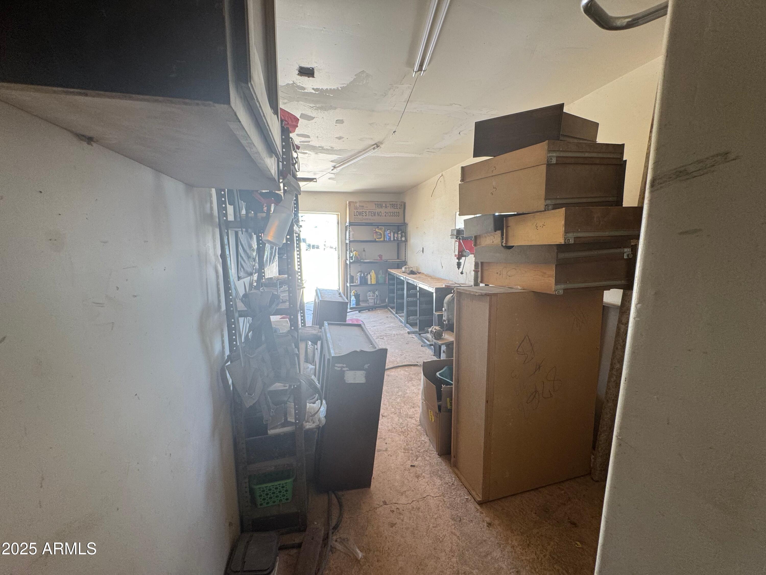 56163 West Papago Road Maricopa, AZ 85139 - Photo 35 of 44 a room with water heater and wooden cabinets