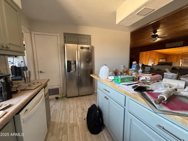 a kitchen with a sink appliances and cabinets