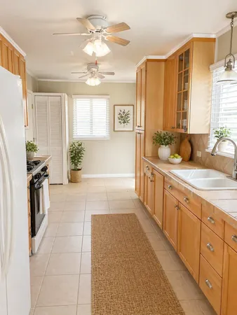 a spacious bathroom with a double vanity sink a mirror a and a shower