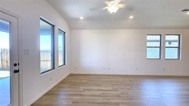 a large kitchen with kitchen island a wooden floor