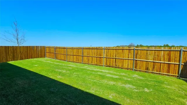 a view of a backyard with a fence